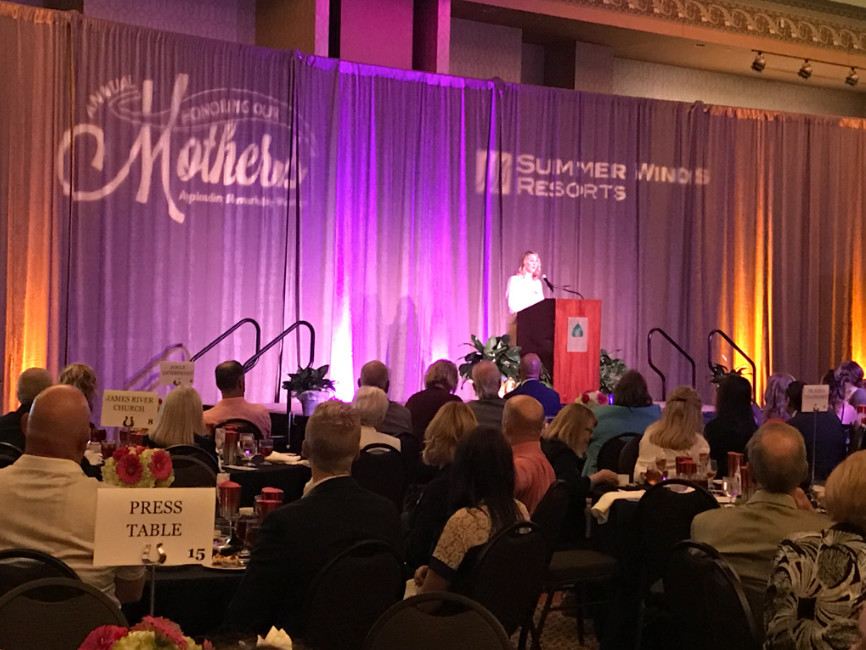 Anne Herschend McGregor welcomes the crowd to Chateau on the Lake  May 4 during The Caring People’s banquet honoring single mothers. She spoke on behalf of her parents, Peter and JoDee Herschend, who were at Mayo Clinic for JoDee’s cancer treatments.